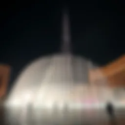Dubai Fountain illuminated at night with Burj Khalifa in the background
